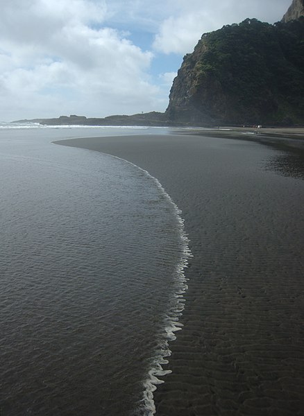 File:Wave advancing across sand ripples, north Karekare beach.jpg