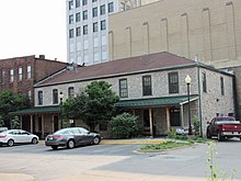 The stone building in the back. Woeber Carriage Works stone building.jpg