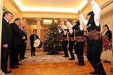 Pontic men dance in a government building