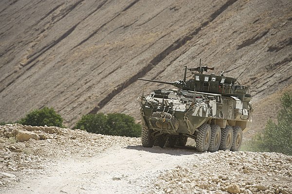 A LAV III performing mounted patrols makes its way through an unpaved road in Bamyan Province.
