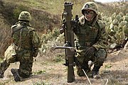 A Japan Ground Self-Defense Force (JGSDF) soldier, right, participates in a simulated combined company attack with U.S