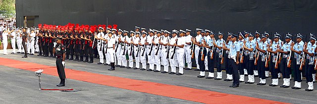 Armed forces saluting the national flag