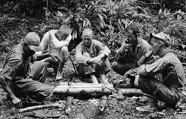 Astronauts participating in tropical survival training at an Air Force Base near the Panama Canal, 1963. From left to right are an unidentified traine