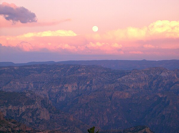 The moon is rising over Copper Canyon