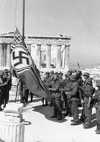 The symbolic beginning of the occupation: German soldiers raising the German War Flag over the Acropolis of Athens. It would be taken down in one of the first acts of resistance by Apostolos Santas and Manolis Glezos.