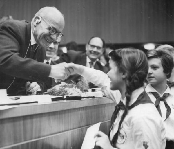 Gomułka (left) greeted by members of the Ernst Thälmann Pioneer Organisation in East Germany.