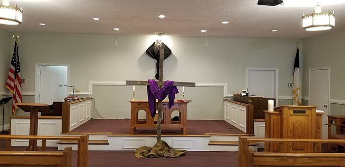 On Maundy Thursday, the altar of this Methodist church was stripped and the crucifix was veiled in black for Good Friday. A wooden cross sits in front of the bare chancel for the veneration of the cross ceremony.