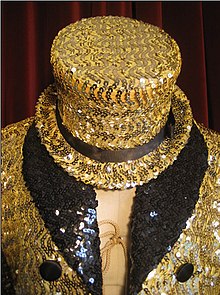 A replica costume based on the film's gold sequined swallow-tail coat worn by Little Nell, recreated by fan Mina Credeur of Houston, Texas. Columbia top hat and tux.jpg