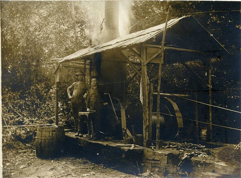 File:Couple of loggers with steam powered donkey engine (5436180147).jpg