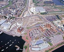Site of the proposed Cardiff Bay Opera House and later Wales Millennium Centre in the open space in the middle of the image Cropped image of site before the construction of the WMC.jpg