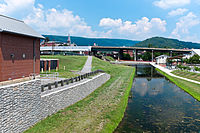 Terminus of the Chesapeake and Ohio Canal in Cumberland. Highway bridge is Interstate 68. Canal Place Museum is the brick building behind bridge. Cumberland Basin looking North.jpg