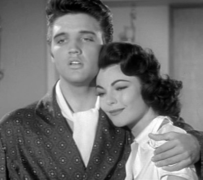 Presley as Vince Everett hugs Judy Tyler as Peggy Van Alden as he sings "Young and Beautiful".