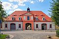 Castle, two stable wings with an L-shaped floor plan (five stable buildings, 18th century and marked 1898), gatehouse with wagon shed, oat storage floor and clock tower (marked 1800), scales, horse statue and baroque tea pavilion and summer stable (marked 1845) with water level indicators 1850, 1862 and 1890 and eight other stud buildings on the paddock (individual monuments to ID no. 09286579)