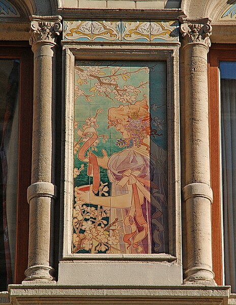 Hand-painted tile panel on the facade of the Grande Maison de Blanc in Brussels (1897–98) designed by Privat Livemont and made by the Boch Frères Kéramis[208]