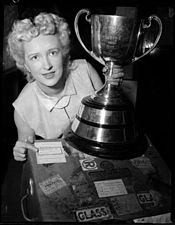 Woman poses with Grey Cup in 1955. Grey Cup VPL 43916 (15892818281).jpg