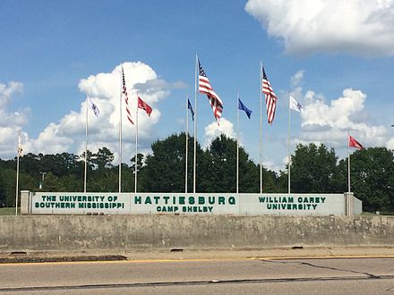 Flagpoles standing behind Hattiesburg, Mississippi sign, 2016