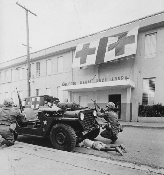 File:Humanitarian G.I.'s. Firefight where G.I. pushes little kid under jeep for protection, Santo Domingo, May 5., 1965 - NARA - 541806 (cropped).jpg