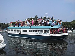 A ferry with drag queens during the Invasion of the Pines arrives at Pines Harbor Invasion of the Pines 2001.jpg