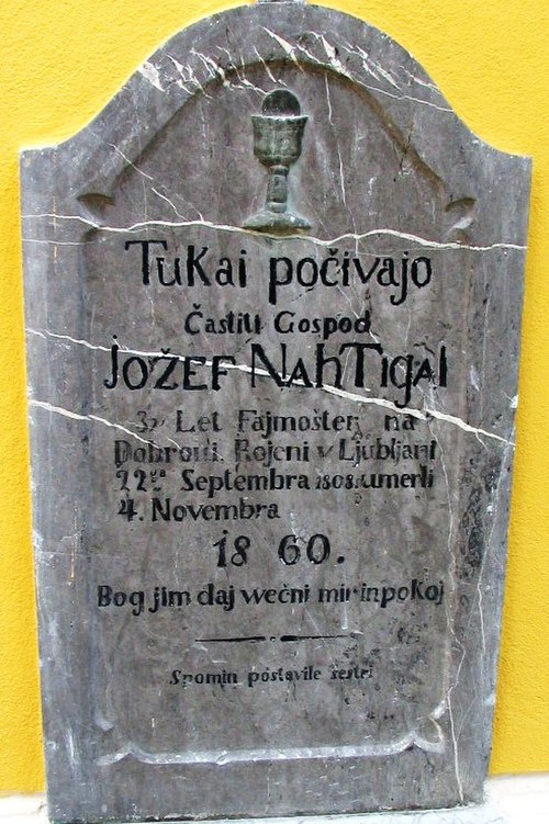 Tombstone of Jožef Nahtigal in Dobrova with archaic Slovene onikanje in indirect reference. Literal translation "Here lie [počivajo] the honorable Jož