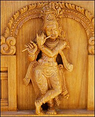 קרישנה רוקד ומנגן בחליל, תבליט עץ ממקדש בהודו.