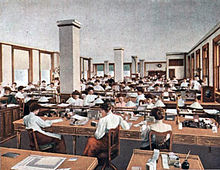 A drawing of workers at desks and in cubicles