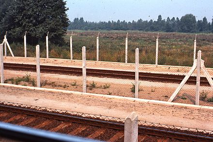West German trains ran through East Germany. This 1977 view shows how barriers were made near the tracks to keep people away.