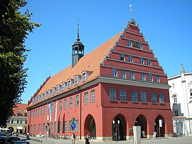 Greifswald's red town hall, the seat of the lord mayor, is situated in the historic city centre. As Greifswald is a small, coastal student town, the relationship between the university and the town has mostly been close. For instance, it was Heinrich Rubenow, then lord mayor of the city, who pushed for the establishment of a university in his town, and who became the university's first rector in the year 1456. Rathaus Greifswald.JPG