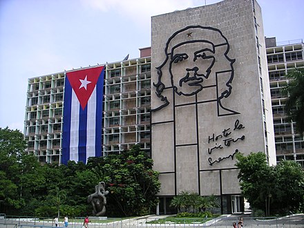 Plaza de la Revolución, in Havana, Cuba. Aside the Ministry of the Interior building where Guevara once worked is a 5-story steel outline of his face. Under the image is Guevara's motto, the Spanish phrase: "Hasta la Victoria Siempre" (English: Until Victory, always).