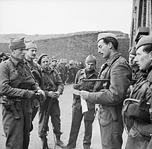 Major Lord Lovat, giving orders to his men before setting out on a commando raid on the French coast near Boulogne, 21 April 1942 The British Army in the United Kingdom 1939-45 H18953.jpg