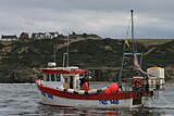 Fishing boat "shooting" a line of creels