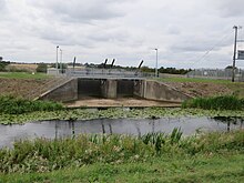 The west sluice allows washland to be flooded to the west of the river to protect the city of Lincoln. Till Washlands West Sluice.jpg