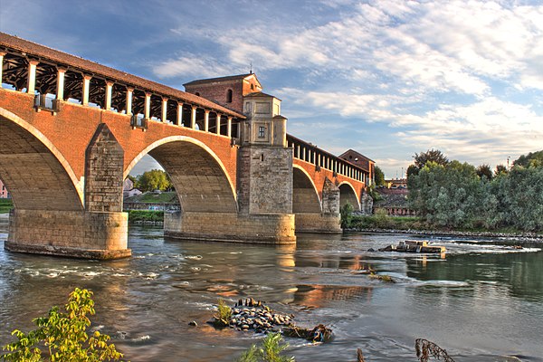 The Ticino and the Ponte Coperto of Pavia (originally medieval in date, rebuilt in 1950 after the destruction due to war bombing)