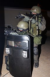A U.S. Marine Corps Military Police Special Reaction Team using the MP5-N in February 2004. USMC MP SRT MP5.JPEG