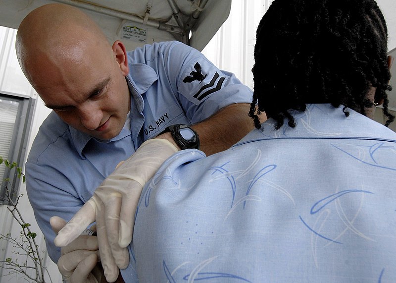 File:US Navy 070926-N-6278K-007 Hospital Corpsman 2nd Class Chad Galvin, a respiratory therapy technician attached to Military Sealift Command hospital ship USNS Comfort (T-AH 20), gives an immunization shot to a patient.jpg