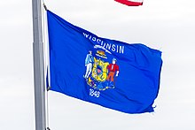 The state flag flies in front of the state capitol Wisconsin State flag at the Capitol.jpg
