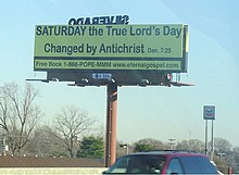 Historic Adventist roadside billboard. Text reads, "SATURDAY the True Lord's Day Changed by Antichrist Dan. 7:25 YellowChurchBillboard.jpg