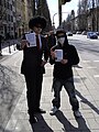 "Anonymous" members with flyers, at anti-Scientology protests (Munich 2008).jpg