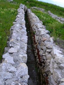 A sanitary channel at Potaissa, Dacia (modern Romania). It is placed cross-slope with a slight decline and then exits down-slope. 2006 0602TurdaPotaissa0122.jpg