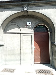 The arched entrance, still bearing the old numbering