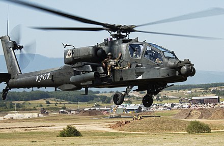 AH-64 during an extraction exercise at Camp Bondsteel, Kosovo in 2007 with a soldier on the avionics bay.