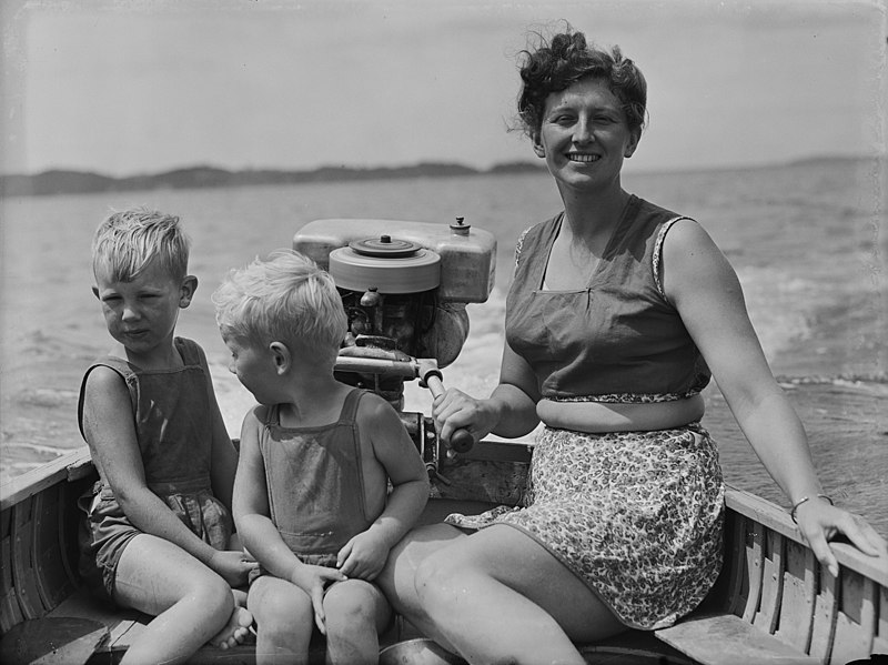 File:A woman and two boys seated in a clinker dinghy (AM 86898-1).jpg