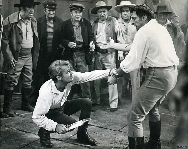Studio publicity photograph showing Alan Ladd's character Bowie (left) in a knife dueling scene with Anthony Caruso's character "Bloody Jack" Sturdiva