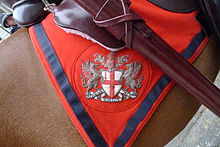 City of London arms on a saddle blanket, as seen outside the Royal Courts of Justice during the Lord Mayor's Show, 2011. Arms of the City of London on an horse blanket 2011.jpg