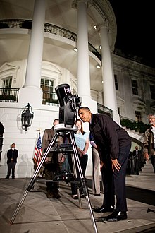 U.S. President Barack Obama views a double star in the constellation Lyra through an 8" Schmidt-Cassegrain telescope during the 2009 White House Astronomy Night. Barack Obama looks through a telescope.jpg