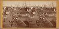 Barrels and cargo on piers, ships in background (NYPL b11707535-G90F270 032F).jpg