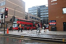 Pedestrians and buses near the bus station