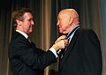 Cooke is presented the Distinguished Federal Civilian Service Medal by William Cohen.