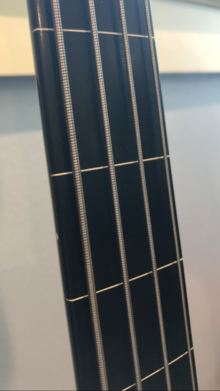 Ebonol fingerboard of a fretless electric bass. Note the shiny color, and the lack of a wood grain. Ebonol Fingerboard of a Squier Fretless Jazz Bass.png
