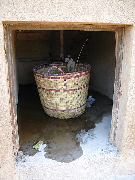 File:Faeces basket in vault. Vault door missing (stolen). Note urine on the ground. (6875947599).jpg