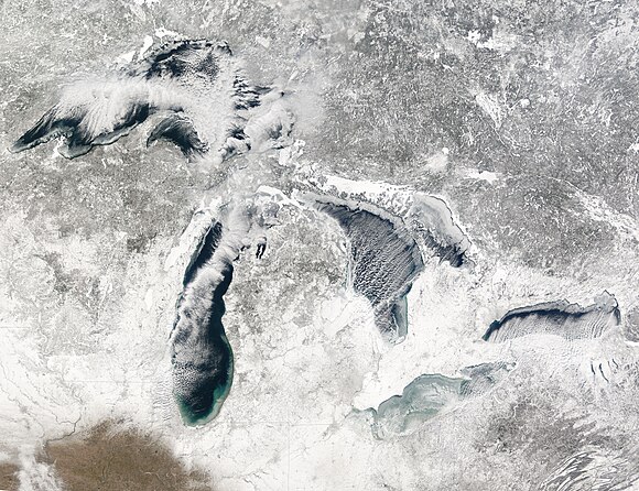 Terra MODIS image of the Great Lakes, January 27, 2005, showing ice beginning to build up around the shores of each of the lakes, with snow on the ground; Green Bay, the North Channel, Saginaw Bay, and Lake St. Clair show substantially complete ice coverage.